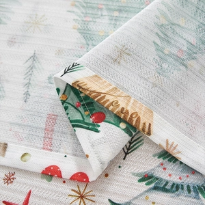 Close-up of Christmas tree fabric detail with neat hemmed stitching and linen texture