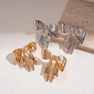 Metallic bow earrings set in gold and silver colors with smooth and textured finishes