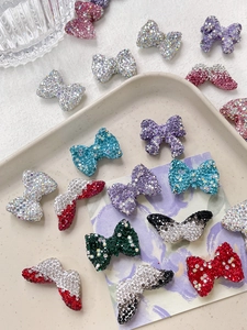 Detailed view of colorful rhinestone bow accessories for DIY jewelry making