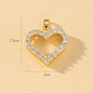 Detailed view of gold copper heart pendant with sparkling cubic zirconia, 2.5cm x 2cm size