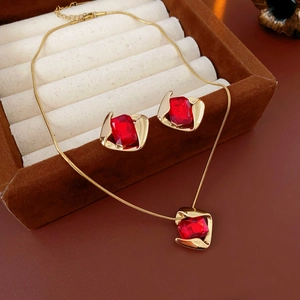 Detailed view of red gemstone jewelry set in a plush velvet storage box