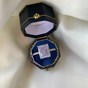 Square-cut lavender high carbon diamond ring in an elegant blue vintage jewelry box