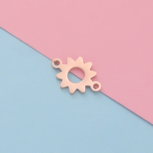 Close-up of rose gold sunflower-shaped stainless steel jewelry pendant on a bicolor background