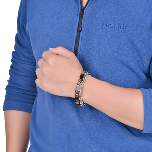 Men's double-layer bracelet with tiger eye beads and silver chain on a male wrist