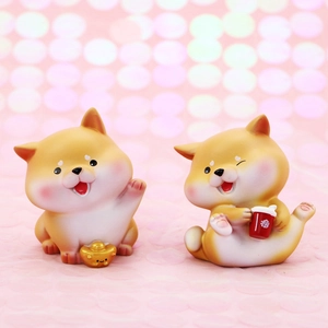 Macro shot of cute Shiba Inu figurines with a golden ingot and red cup car decor