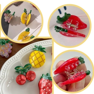 Detailed close-up showing strawberry, pineapple, cherry and grape acrylic fruit hair claws