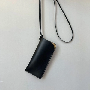 Leren zonnebriltasje met nekriem, draagbaar minimalistisch brillenhoesje detail.