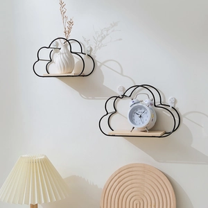Cloud-shaped wall shelves with black iron frames and wooden base in a cozy home setting