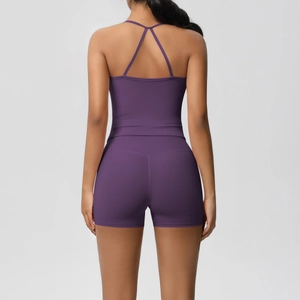 Detail of purple two-piece yoga set featuring a criss-cross back top and high-waist shorts