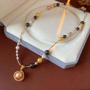 Detail of luxury pearl necklace with zircon pendant resting in a velvet jewelry box