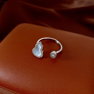 Macro shot of silver wulu ring with mother of pearl inlay and round zircon detail