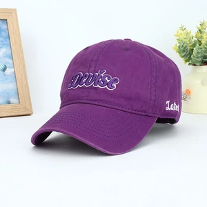 Dark purple baseball cap with Devise embroidery and side Late script on white table