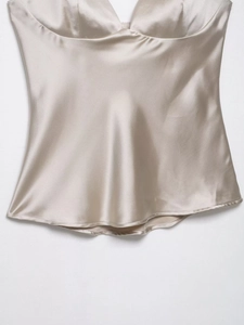 Close-up of champagne satin camisole showing smooth fabric texture and heart neckline