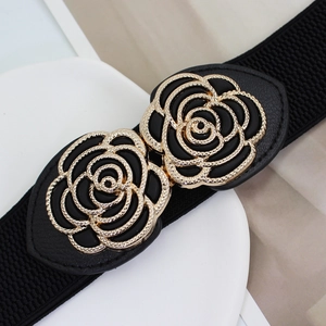 Elastic black waist belt for women with golden double rose flower buckle on white surface