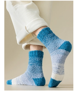 Close-up of blue and white striped coral fleece socks worn for home comfort