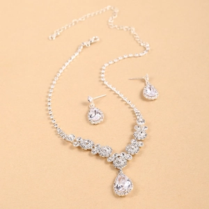 Elegant silver teardrop necklace and earring set with shimmering crystal stones for weddings