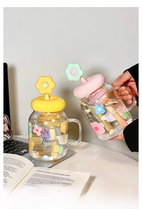 Detail of creative flower glass mug featuring embossed floral lid and stirring rod
