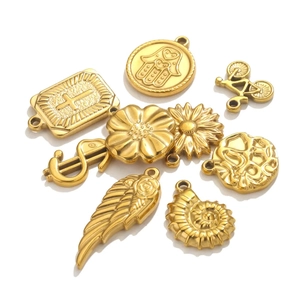 Set of 8 gold stainless steel charms including cross, hamsa, and shell for DIY jewelry
