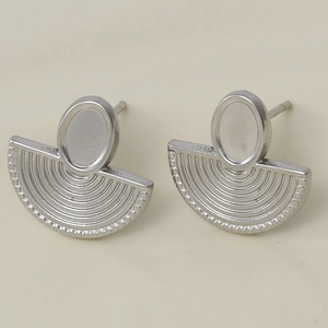 Macro detail of silver fan-shaped 304 stainless steel earrings with concentric textures