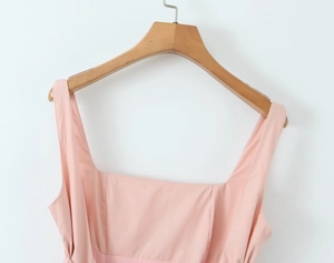 Detail of light pink square neck dress with wide straps and smooth woven fabric texture