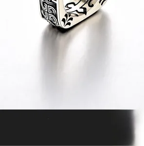 Macro shot of retro wide band ring with engraved tribal patterns on silver steel surface