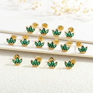 Detail of 18K gold plated earrings with green emerald-cut zircon stones in a crown shape
