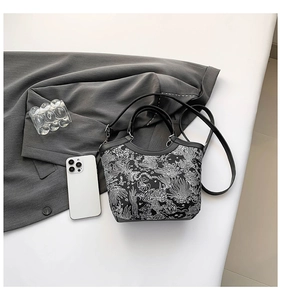 Detail view of New Chinese style bucket bag with elegant black and white floral embroidery