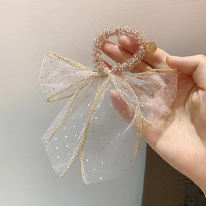 Detailed shot of pink crystal beaded hair tie with a large gold-edged mesh bow accessory