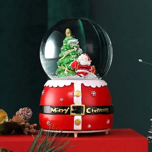 Detailed view of the Christmas snow globe with a Santa figure and glowing red base