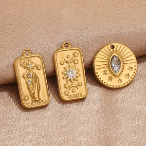 Vintage gold 3D embossed Tarot pendants with cubic zirconia stars and sun on silk background