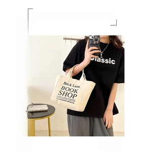 Detail view of durable canvas handbag featuring black London bookstore screen printing