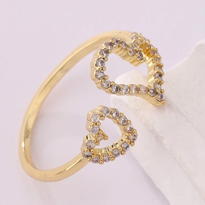 Macro shot of 18K gold plated heart ring featuring detailed white zircon pave setting