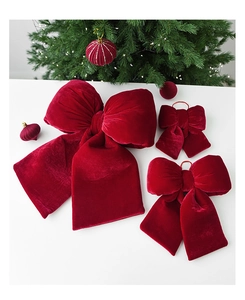 Detailed view of three sizes of luxury red velvet Christmas bows for tree decoration