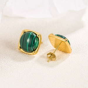 Elegant gold square stud earrings featuring natural green malachite stones on a beige base