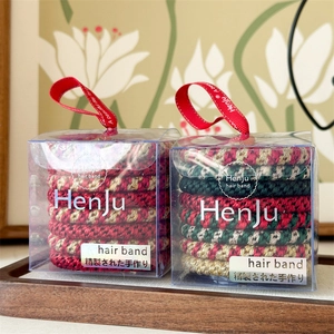 8-pack Christmas hair ties set in red, green and gold braided styles in a gift box