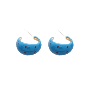 Blue C-shaped earrings with red polka dots and gold studs on a clean white background
