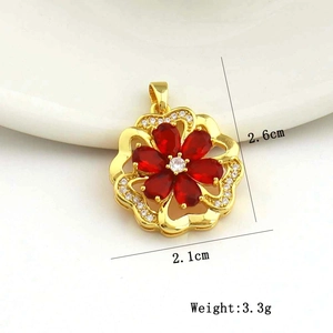 Macro detail of red zircon flower pendant showing 2.6cm height and 2.1cm width dimensions