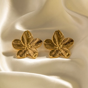 French vintage matte gold flower stud earrings in stainless steel on white silk