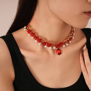 Detailed close-up of vintage multilayer choker with red gemstones and white pearls on model