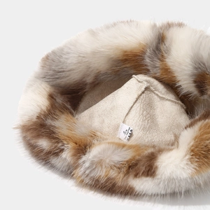 Detailed macro view of the warm faux fur bucket hat lining and 100% polyester wash label