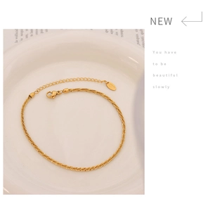Detail of 18K gold-plated anklet showing lobster clasp and K18 hallmark tag