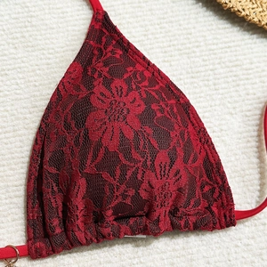 Close-up of red floral lace bikini top with delicate stitching and metal ring detail