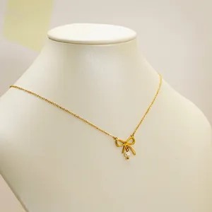 French bow pearl pendant necklace in 18K gold plated finish on female neck model