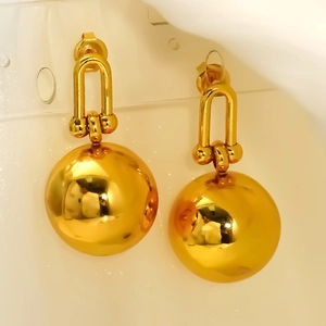 Polished gold horseshoe link earrings with large metal sphere pendants for women