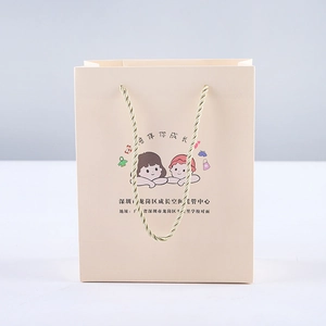 Pink paper gift bag with golden rope handles featuring custom cartoon children print