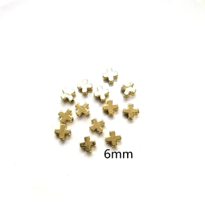 Detailed view of 6mm 14K gold filled cross shaped beads for DIY jewelry making