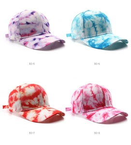 Macro shot showing four colorful tie-dye patterns and twill cotton texture on baseball caps