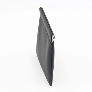 Close-up of minimalist black matte leather storage pouch with metal squeeze closure