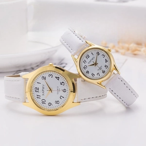 Couples white leather strap watches with gold cases and quartz dials in a lifestyle setting