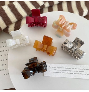 Detailed set of 6 mini acetate bow hair claws in various textures and marble patterns